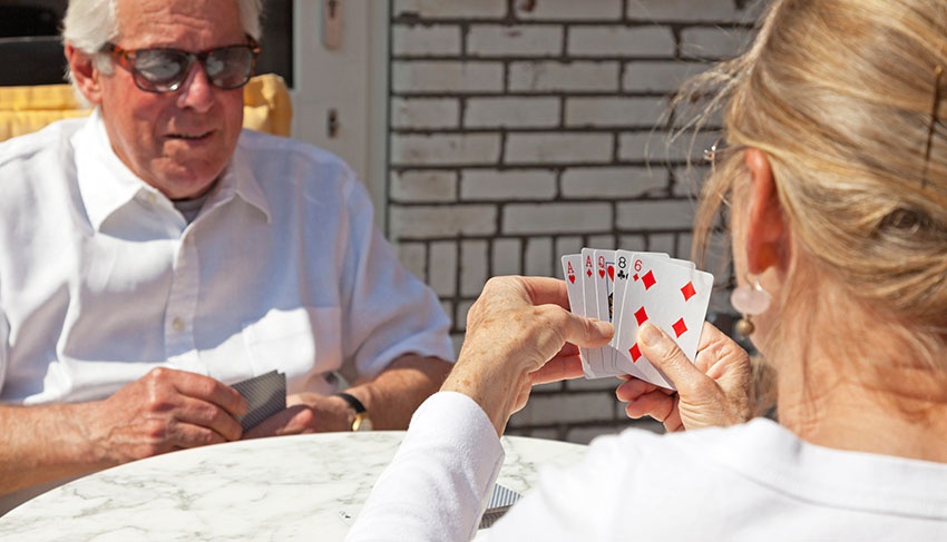 Old couple playing cards